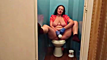 Shaved milf masturbates with dildo in toilet