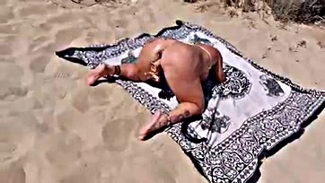 A woman gets screwed on a beach