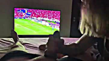 Newlywed wife sucks husband's cock during football match