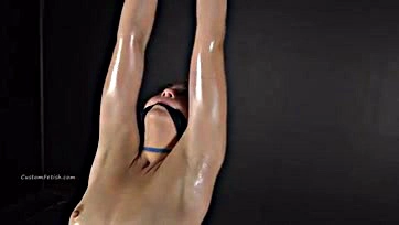 Sexy model suspended, arms up, damsel in distress