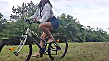 Teen girl masturbates on bike in public park