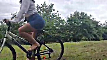 Teen girl masturbates on bike in public park